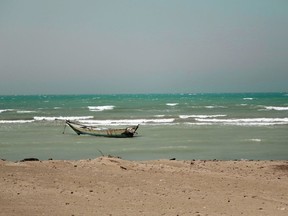 FILE - In this Feb. 12, 2018 file photo, a small boat is anchored near the Red Sea port of Hodeida, Yemen. The Saudi-led coalition backing Yemen's exiled government began an assault Wednesday, June 13, 2018 on the port city of Hodeida, the main entry point for food in a country already teetering on the brink of famine.