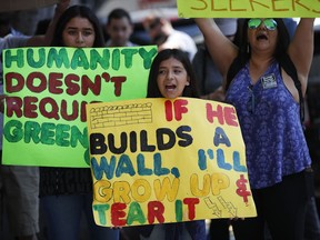 Laylah Martinez, 9, center, chants slogans during a protest outside the the Millennium Biltmore Hotel Tuesday, June 26, 2018, in Los Angeles. U.S. Attorney General Jeff Sessions gave a speech at the hotel.