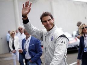 Spain's Rafael Nadal waves to supporters prior to the start of the 86th 24-hour Le Mans endurance race, in Le Mans, western France, Saturday, June 16, 2018.