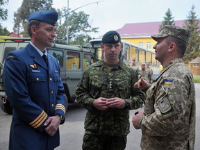 Canadian and Ukrainian servicemen talk during a joint military exercise in Lviv, Ukraine, on Sept. 14, 2015.
