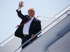 President Donald Trump steps off Air Force One as he arrives for the G7 Summit, Friday, June 8, 2018, in Canadian Forces Base Bagotville, Canada.