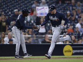 Atlanta Braves' Freddie Freeman, right, is congratulated by third base coach Ron Washington after Freeman hit a home run during the third inning against the San Diego Padres in a baseball game Tuesday, June 5, 2018, in San Diego.