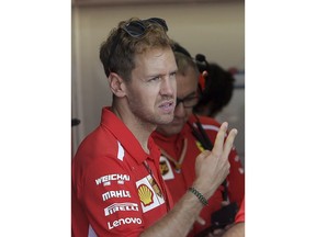 Ferrari driver Sebastian Vettel of Germany, speaks with a team member on the pits of the track of the Paul Ricard racetrack, in Le Castellet, southern France, Thursday, June 21, 2018. The Formula one race will be held on Sunday.