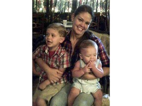 FILE - In this 2013, file photo provided by her mother, Gina Waters-Colbert, Autumn Steele poses with her sons, Kai, left, and Gunner at her mother's home in Columbus, Ga. The city of Burlington, Iowa, has agreed to pay an undisclosed sum to settle a wrongful death lawsuit brought by the family of Steele, who was mistakenly shot and killed by a police officer, attorneys confirmed Wednesday, June 6, 2018. The deal resolves a lawsuit that claimed a police officer acted recklessly when he killed Steele, and then participated in a cover-up that portrayed the shooting as justified as a result of an attacking dog.