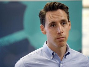 FILE - In this May 25, 2018, file photo, Missouri Attorney General and Republican U.S. Senate candidate Josh Hawley takes questions from the media after touring an ethanol plant in Macon, Mo. The end of Missouri Gov. Eric Greitens' tenure as governor Friday, June 1, 2018, could breathe new life into Hawley's campaign. He's seeking to unseat Democratic Sen. Claire McCaskill in what's expected to be one of the most contentious races in the nation, a challenging task not helped by turmoil in the governor's office.