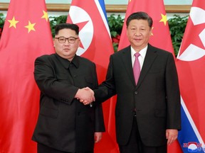 In this May 7, 2018, photo provided by the North Korean government, North Korean leader Kim Jong Un, left, meets Chinese President Xi Jinping in Dalian, China.