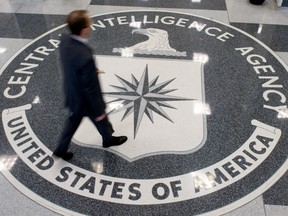 This August 14,2008 file photo shows a man as he crosses the Central Intelligence Agency (CIA) logo in the lobby of CIA Headquarters in Langley, Virginia. The former CIA officer, on trial in Alexandria, Virginia, federal court for espionage, freely told his old colleagues that he had been approached by those spies on social media in February of 2017.