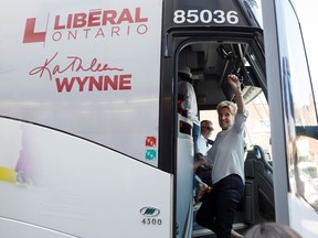 Ontario Liberal Party Leader Kathleen Wynne waves as she boards her bus following a campaign stop at a west end Toronto street festival on Saturday, June 2, 2018 in Toronto, Ontario.