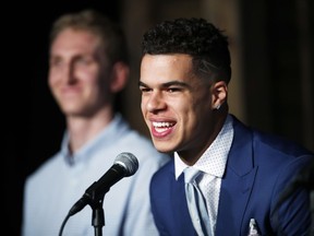 Michael Porter Jr., the Denver Nuggets first-round pick in the NBA Draft, jokes with reporters as one of the team's two, second-round selections, Thomas Welsh, looks on during a news conference to introduce the players to the media Friday, June 22, 2018, in Denver.