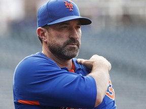 New York Mets manager Mickey Callaway watches his players warm up for a baseball game against the Colorado Rockies on Wednesday, June 20, 2018, in Denver.