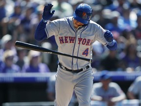 New York Mets' Wilmer Flores reacts after hitting an RBI-sacrifice fly off Colorado Rockies relief pitcher Yenoy Almonte during the eighth inning of a baseball game Thursday, June 21, 2018, in Denver. The Rockies won 6-4.