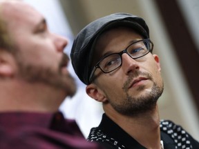 Charlie Craig, front, and David Mullins talk about a U.S. Supreme Court ruling that sets aside a Colorado court decision against a baker who would not make a wedding cake for the same-sex couple as they meet reporters Monday, June 4, 2018, in Denver. The Court has not decided on the larger issue in the case, however--whether a business can refuse to to serve gay and lesbian people.