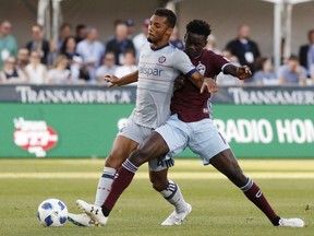 Colorado Rapids forward Dominique Badji, right, competes for control of the ball with Chicago Fire defender Johan Kappelhof during the first half of an MLS soccer match Wednesday, June 13, 2018, in Commerce City, Colo.