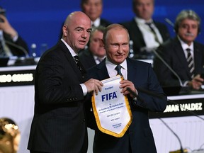 Russian President Vladimir Putin, right, and FIFA president Gianni Infantino participate in the 68th FIFA Congress at the Expocentre in Moscow on June 13, 2018.