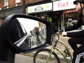 Cyclists ride on the designated Bloor Street bike lanes in Toronto on Thursday, October 12, 2017. dvocates, politicians and members of the public are demanding Toronto make its streets safer for cyclists and pedestrians after a string of recent deaths highlighted just how dangerous the city's roads can be.