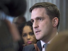 Benjamin Perryman, Abdoul Abdi's lawyer, fields questions as Abdi's sister, Fatouma Abdi, looks on at Federal Court after a hearing to determine whether deportation proceedings should be halted for the former child refugee, in Halifax on February 15, 2018. A judicial review is scheduled for today in the case of Abdoul Abdi, a former Somali child refugee fighting to stay in Canada. The Canada Border Services Agency detained Abdi, who was never granted Canadian citizenship while growing up in foster care in Nova Scotia, after he served about five years in prison for multiple offences including aggravated assault.