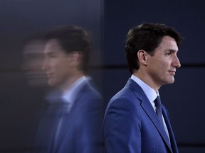 Prime Minister Justin Trudeau is reflected in a TV screen as he speaks at a press conference in Ottawa on June 20, 2018. A United Nations housing watchdog is taking the Liberals to task over what she sees as the government's about-face on a promise to put a human rights lens on its housing strategy. In a scathing letter to Prime Minister Trudeau, Leilani Farha, the UN special rapporteur on the right to housing, says her support for the strategy is waning. She says her charge of heart is based on indications the Liberals "may not recognize the right to housing" in legislation expected this fall that would enshrine the 10-year, $40-billion program into law.
