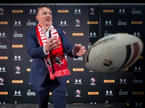 Two rugby teams seemingly headed in different directions clash Saturday in Halifax with Canada coach Kingsley Jones hopes his charges will respond after a lacklustre showing in a lopsided loss to Russia. Jones passes a ball while posing for a photograph after he was introduced as the new coach of Canada's national team, in Vancouver on Tuesday, October 24, 2017.