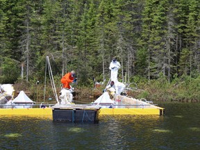 Researchers and professional spill responders monitor a deliberate spill of oilsands bitumen and crude oil into a lake in northwestern Ontario in an experiment over how the ecosystem responds in this undated handout photo. The pilot project, known as Freshwater Oil Spill Remediation Study, is being done at the International Institute for Sustainable Development Experimental Lakes Area southeast of Kenora, Ont.