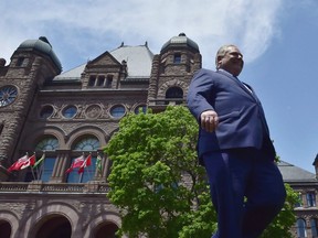 Doug Ford walks out onto the front lawn of the Ontario Legislature at Queen's Park in Toronto on June 8, 2018.