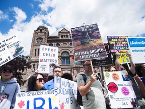 Parents of children with autism protest the government's decision to cut Intensive behavioural Intervention therapy for children age five and older at Queen's Park in Toronto on Monday, June 6, 2016. Parents of children with autism are skeptical of PC Leader Doug Ford's funding promise.