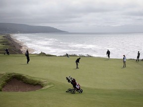 A golfers putt on the 331 yard, par 4, 17th hole at Cabot Cliffs, the seaside links golf course rated the 19th finest course in the world by Golf Digest, is seen in Inverness, N.S. on June 1, 2016. Cape Breton's famed Cabot Links golf resort is getting a $2-million federal loan, bringing the total government funding for the luxurious links to almost $17 million. The Atlantic Canada Opportunities Agency says the interest-free, $2-million "repayable contribution" will go towards spa facilities, high-end culinary services and tennis courts at Cabot Cliffs at Broad Cove, the sibling golf course to Cabot Links.