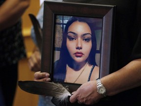 Delores Daniels holds a photo of her daughter Serena McKay who was murdered three months ago in Sagkeeng during a press conference calling for a re-organization of the National Inquiry into Missing and Murdered Indigenous Women and Girls (MMIWG) in Winnipeg, Wednesday, July 12, 2017. A teenager who helped attack a young Manitoba woman and shared the footage of her bloody death has been sentenced to just over three years in jail.