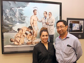 Dr. Lizbeth Hernandez-Ronquillo, left, and Dr. Jose Tellez-Zenteno pose in front of Mexican artist Eduardo Urbano Merino's painting "Epilepsy, leaving the nightmare behind" in this undated handout photo. A new study suggests that incidence of epilepsy for Indigenous Canadians is twice that of their non-Indigenous counterparts.