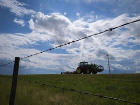 Farm machinery travels along highway 884 bordering CFB Suffield, Alta., Tuesday, July 26, 2016. New health and safety rules for farm and ranch workers in Alberta will come into effect in December, three years after the province passed legislation.