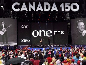 U2's Bono, right, and The Edge perform on stage during the Canada Day noon hour show on Parliament Hill in Ottawa on July 1, 2017. Officials are promising shorter queue times for Canada Day festivities in the nation's capital this year, but heavy security measures will once again force revellers to endure enhanced screening and tightly controlled access to Parliament Hill.