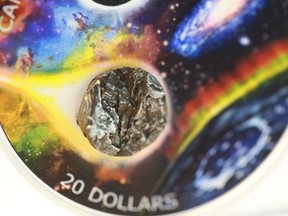 The Royal Canadian Mint has unveiled a pure silver coin containing a small chip from a meteorite to mark the 150th anniversary of the Royal Astronomical Society of Canada. Detail of the meteorite attached to the new twenty dollar silver coin from the Royal Canadian Mint is seen in an undated handout image.