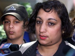 Suman Virk, mother of murdered teen Reena Virk, and her son Aman, left, talk to reporters outside court in Vancouver Thursday, April 20, 2000 following the sentencing of Kelly Ellard who was convicted in the killing. The mother of slain Victoria-area teen Reena Virk, whose death more than two decades ago made international headlines about youth bullying, has died. Suman Virk was 58 years old.THE CANADIAN PRESS/Chuck Stoody