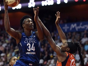 Minnesota Lynx center Sylvia Fowles (34) shoots over Connecticut Sun forward Chiney Ogwumike (13) during the first half of a WNBA basketball game, Saturday, June 9, 2018, at Mohegan Sun Arena in Uncasville, Conn.