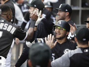 Chicago White Sox's Yolmer Sanchez is congratulated for his home run off Cleveland Indians starting pitcher Adam Plutko during the first inning of a baseball game Tuesday, June 12, 2018, in Chicago.