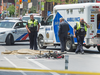 Police investigate the scene where a woman cyclist was killed in a traffic accident in Toronto on June 12, 2018. The annual number of cyclist deaths and serious non-fatal injuries has remained stable in the city over the last decade.