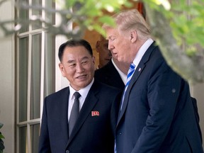 President Donald Trump talks with Kim Yong Chol, former North Korean military intelligence chief and one of leader Kim Jong Un's closest aides, as they walk from their meeting in the Oval Office of the White House in Washington, Friday, June 1, 2018.