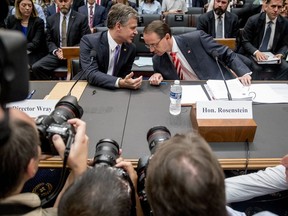 Deputy Attorney General Rod Rosenstein, right, and FBI Director Christopher Wray, left, arrive to testify before a House Judiciary Committee hearing on Capitol Hill in Washington, Thursday, June 28, 2018, on Justice Department and FBI actions around the 2016 presidential election.