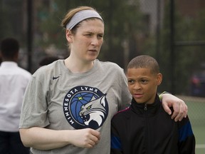 WNBA Champion Minnesota Lynx guard Lindsay Whalen walks with student fifth grade student Ethan Shepard at Payne Elementary School in Washington, Wednesday, June 6, 2018. Payne Elementary has the highest homeless student population in the district.
