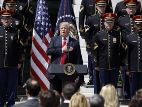 President Donald Trump sings the national anthem during a "Celebration of America" event on the South Lawn of the White House, Tuesday, June 5, 2018, in Washington. Trump quickly scheduled the event with military bands after canceling a visit with the Philadelphia Eagles as he stoked fresh controversy over players who protest racial injustice by taking a knee during the national anthem.