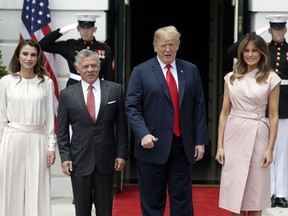 President Donald Trump and first lady Melania Trump pose for a photo with King Abdullah II of Jordan and Queen Rania at the White House, Monday, June 25, 2018, in Washington.