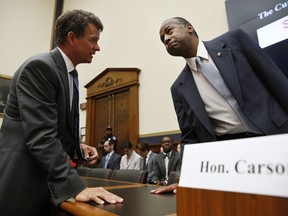 Housing and Urban Development Secretary Ben Carson, right, listens to Rep. Dave Trott, R-Mich., left, as Carson arrives to testify to the House Financial Services Committee, Wednesday, June 27, 2018, on Capitol Hill in Washington.
