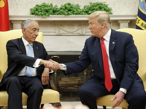 President Donald Trump and Portuguese President Marcelo Rebelo de Sousa shake hands in the Oval Office of the White House in Washington, Wednesday, June 27, 2018.