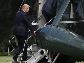 President Donald Trump looks over while boarding Marine One helicopter for his departure from the South Lawn of the White House in Washington, Friday, June 29, 2018, for the short flight to nearby Andrews Air Force Base, Md.