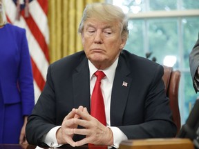 President Donald Trump listens to Vice President Mike Pence speak before signing an executive order to end family separations at the border, during an event in the Oval Office of the White House in Washington, Wednesday, June 20, 2018.