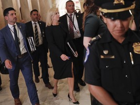 Homeland Security Secretary Kirstjen Nielsen, center, walks at the U.S. Capitol in Washington, after attending a meeting with President Donald Trump and members of the GOP leadership, Tuesday, June 19, 2018.