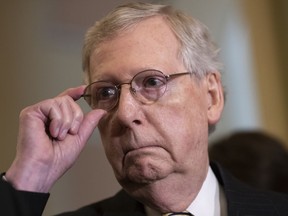 Senate Majority Leader Mitch McConnell, R-Ky., tells reporters he intends to cancel the traditional August recess and keep the Senate in session to deal with backlogged tasks, on Capitol Hill in Washington, Tuesday, June 5, 2018.