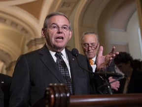 Sen. Bob Menendez, D-N.J., the ranking member of the Senate Foreign Relations Committee, joined at right by Senate Minority Leader Chuck Schumer, D-N.Y., talks to reporters on Capitol Hill in Washington, Tuesday, June 12, 2018. Republican and Democratic leaders aren't quite celebrating President Donald Trump's historic meeting Tuesday with North Korea's Kim Jong Un, saying the initial agreement they struck won't mean much unless the North completely denuclearizes.