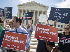 Activists rally at the Supreme Court as President Donald Trump prepares to choose a replacement for Justice Anthony Kennedy, on Capitol Hill in Washington, Thursday, June 28, 2018.