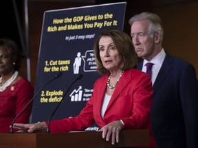 House Minority Leader Nancy Pelosi, D-Calif., flanked by Rep. Val Demings, D-Fla., left, and Rep. Richard Neal, D-Mass., the ranking member of the House Ways and Means Committee, asserts that the debt created by the Republican tax cut enacted six months ago was a step toward compromising Social Security and Medicare, during a news conference on Capitol Hill, in Washington, Wednesday, June 20, 2018.