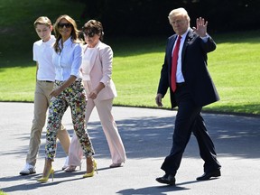President Donald Trump, right, waves as he walks with first lady Melania Trump, second from left, his son Barron Trump, left, and mother-in-law Amalija Knavs, second from right, as they walk along the South Lawn of the White House in Washington, Friday, June 29, 2018, as they head to Marine One for the short trip to Andrews Air Force Base in Maryland. The Trumps are heading to New Jersey for the weekend.